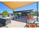 Outdoor kitchen and grilling area with seating, BBQ grills, and counter space at 2506 Verdello St, Henderson, NV 89044