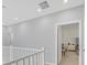 Hallway with light gray walls, white trim, and a view of the second bedroom at 2506 Verdello St, Henderson, NV 89044