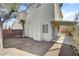 Expansive backyard featuring a covered patio, brick wall, and mature landscaping at 2573 Rafferty Creek Ln, Las Vegas, NV 89156