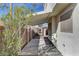 Backyard view showcasing a covered patio, storage shed, and well-defined walkway at 2573 Rafferty Creek Ln, Las Vegas, NV 89156