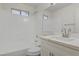 Bright bathroom featuring a shower-tub combo, white vanity, and medicine cabinet at 2573 Rafferty Creek Ln, Las Vegas, NV 89156