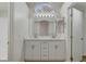 Modern bathroom with dual sinks, marble countertop, and framed mirror with vanity lighting at 2573 Rafferty Creek Ln, Las Vegas, NV 89156