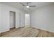 Cozy bedroom featuring wood-look flooring, ceiling fan and closet, providing a peaceful retreat at 2573 Rafferty Creek Ln, Las Vegas, NV 89156