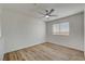 Light and airy bedroom with wood-look flooring, ceiling fan, and window with horizontal blinds at 2573 Rafferty Creek Ln, Las Vegas, NV 89156