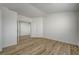 Neutral bedroom with wood-look flooring, white walls, and a closet, ready for personalization at 2573 Rafferty Creek Ln, Las Vegas, NV 89156