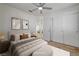 Bright bedroom with light hardwood floors, neutral walls, ceiling fan and closet at 2573 Rafferty Creek Ln, Las Vegas, NV 89156