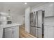Open eat-in kitchen with stainless steel appliances and white countertop at 2573 Rafferty Creek Ln, Las Vegas, NV 89156