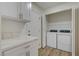 Functional laundry room with white cabinets and a side-by-side washer and dryer setup at 2573 Rafferty Creek Ln, Las Vegas, NV 89156
