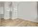 Open living room with lots of natural light and hardwood floors at 2573 Rafferty Creek Ln, Las Vegas, NV 89156