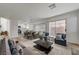 Open-concept living area with dining space, a fireplace, and sliding glass doors at 2573 Rafferty Creek Ln, Las Vegas, NV 89156