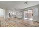 Bright living room with hardwood floors that connect to the kitchen and backyard patio at 2573 Rafferty Creek Ln, Las Vegas, NV 89156