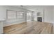 Open living room with hardwood floors, fireplace, modern lighting, and lots of natural light at 2573 Rafferty Creek Ln, Las Vegas, NV 89156