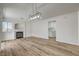 Open living room with hardwood floors and a fireplace at 2573 Rafferty Creek Ln, Las Vegas, NV 89156
