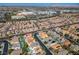 An aerial neighborhood view showcasing the landscape and rooftops in a sunny community at 283 New River Cir, Henderson, NV 89052