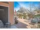 Outdoor patio space with comfortable seating, greenery, and a view of neighboring homes at 283 New River Cir, Henderson, NV 89052