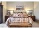 Spacious primary bedroom with a large bed, decorative pillows, and natural light from sliding glass doors at 283 New River Cir, Henderson, NV 89052