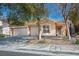 Inviting single-story home with a three car garage, tiled roof, and desert landscaping at 283 New River Cir, Henderson, NV 89052