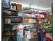 Organized garage space with shelving units for storage and a variety of items neatly arranged at 283 New River Cir, Henderson, NV 89052
