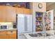 Kitchen featuring granite countertops, a double-door refrigerator, custom cabinets and a pantry at 283 New River Cir, Henderson, NV 89052