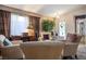 Inviting living room with comfortable seating arrangement and a large window bringing in ample natural light at 283 New River Cir, Henderson, NV 89052