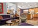 Bright and airy living room with a partial view of the kitchen, featuring comfortable seating and stylish decor at 283 New River Cir, Henderson, NV 89052