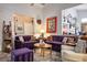 Comfortable living room with plush purple sofas, a wooden coffee table, and various decorative accents at 283 New River Cir, Henderson, NV 89052