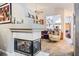 Open living space with a decorative fireplace, stylish furnishings, and an archway leading to other rooms at 283 New River Cir, Henderson, NV 89052