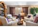Well-decorated living room featuring a cozy seating area, warm lighting, and decorative shelving with books and plants at 283 New River Cir, Henderson, NV 89052