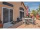 Back patio area with a table, chairs, and plenty of space for outdoor entertaining at 283 New River Cir, Henderson, NV 89052