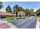 Gated community entrance with a security booth and lush landscaping at 2851 S Valley View Blvd # 1079, Las Vegas, NV 89102