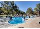 Resort-style community pool with ample seating, surrounded by mature trees and lush landscaping at 2851 S Valley View Blvd # 1079, Las Vegas, NV 89102