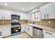 Bright kitchen with white cabinets, granite countertops, blue oven and stainless steel appliances at 2851 S Valley View Blvd # 1079, Las Vegas, NV 89102