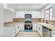 Well-lit kitchen featuring granite countertops, white cabinetry, and modern stainless steel appliances at 2851 S Valley View Blvd # 1079, Las Vegas, NV 89102