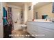 Hallway bathroom featuring a tub and shower, white tiled walls, and a solid white vanity at 294 Dedication Ave, Henderson, NV 89011