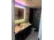 Remodeled bathroom featuring an illuminated mirror, and marble countertop with an undermount sink at 2970 Juniper Hills Blvd # 102, Las Vegas, NV 89142