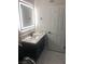 Modern bathroom design featuring a vanity with illuminated mirror, and stylish marble tile flooring at 2970 Juniper Hills Blvd # 102, Las Vegas, NV 89142