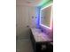 Modern bathroom featuring a large vanity with a unique countertop and lighted mirror at 2970 Juniper Hills Blvd # 102, Las Vegas, NV 89142