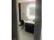 Modern bathroom featuring a sleek vanity, illuminated mirror, and stylish black and white tile at 2970 Juniper Hills Blvd # 102, Las Vegas, NV 89142