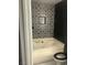 Charming bathroom with black and white tile accents, a bathtub, and modern fixtures at 2970 Juniper Hills Blvd # 102, Las Vegas, NV 89142