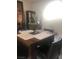 Dining area with wood table and chairs, set near a bright window, and decorated with fruit centerpiece at 2970 Juniper Hills Blvd # 102, Las Vegas, NV 89142