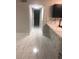 Clean hallway with marble floors connects kitchen with granite counters and more rooms at 2970 Juniper Hills Blvd # 102, Las Vegas, NV 89142