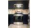 Close-up of oven, marble countertops, and stainless-steel appliances in a modern kitchen at 2970 Juniper Hills Blvd # 102, Las Vegas, NV 89142