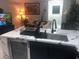 Modern kitchen with marble countertops, a stainless steel sink, and sleek dark cabinetry at 2970 Juniper Hills Blvd # 102, Las Vegas, NV 89142