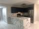 Modern kitchen features waterfall island, stainless steel appliances, and marble floors at 2970 Juniper Hills Blvd # 102, Las Vegas, NV 89142