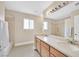 Bathroom featuring dual sinks, a wide mirror, bright lighting, and a shower over tub at 3367 Trickling Stream Cir, Las Vegas, NV 89117