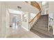 Bright foyer with tile floors, staircase, and open view to the living spaces at 3367 Trickling Stream Cir, Las Vegas, NV 89117