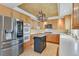 Modern kitchen with stainless steel appliances, quartz countertops, and wood floors at 3367 Trickling Stream Cir, Las Vegas, NV 89117