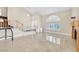 Spacious living room with vaulted ceilings, tiled floors, and large windows with plantation shutters at 3367 Trickling Stream Cir, Las Vegas, NV 89117