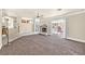 Spacious living room features a cozy fireplace and sliding glass doors to the pool area at 3367 Trickling Stream Cir, Las Vegas, NV 89117