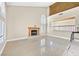 Bright living room with fireplace, tile floors, and large windows providing ample natural light at 3367 Trickling Stream Cir, Las Vegas, NV 89117